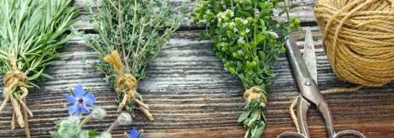posy of fresh herbs with scissors and string